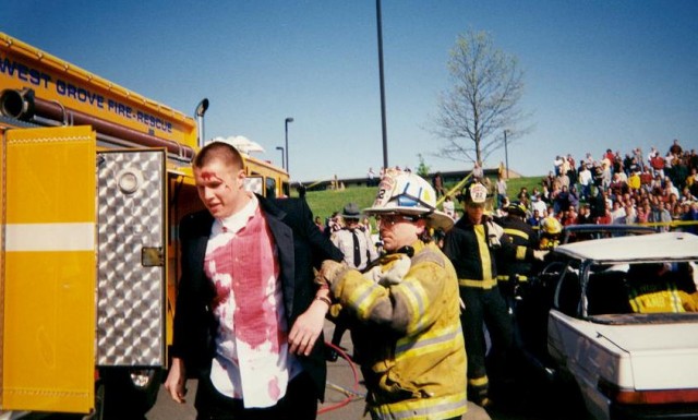 Lt. John Haftl leads away a &quot;victim&quot; at the mock crash at AGHS in 1998
